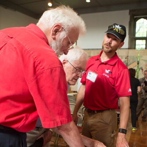 alumni veterans at a booth